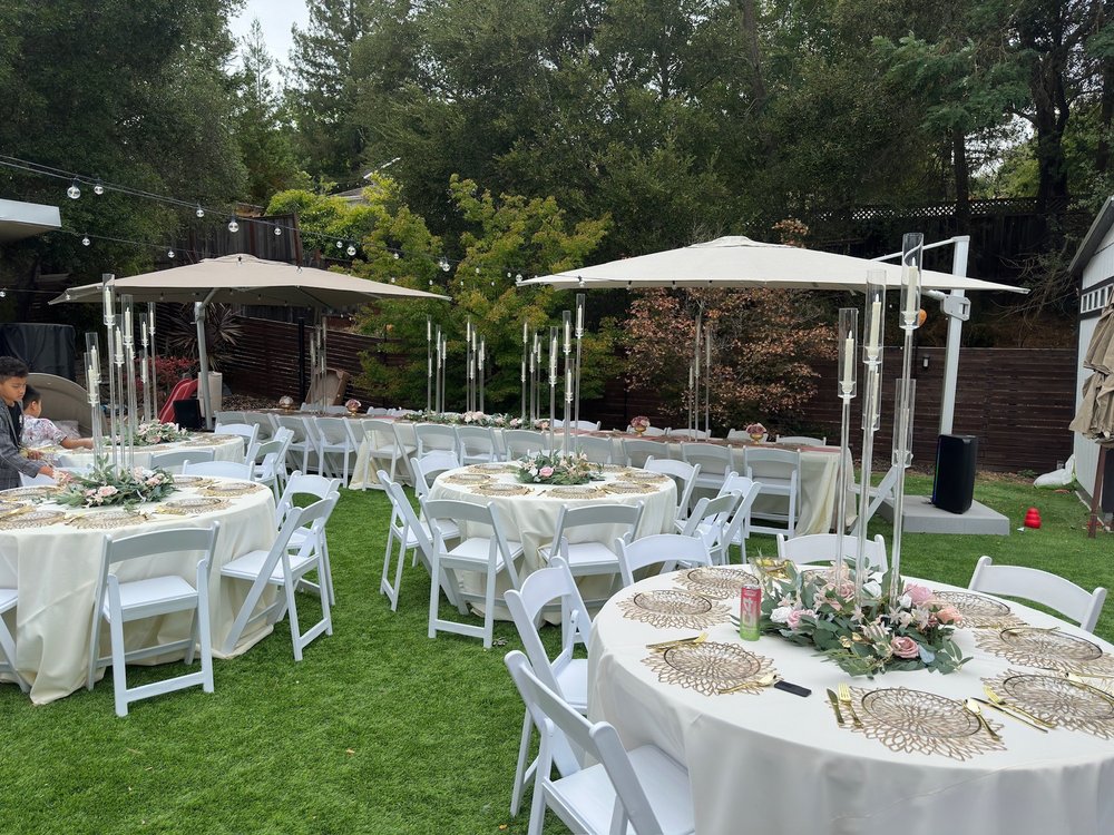 Outdoor celebration tent with tables and chairs rental setup in Brisbane California