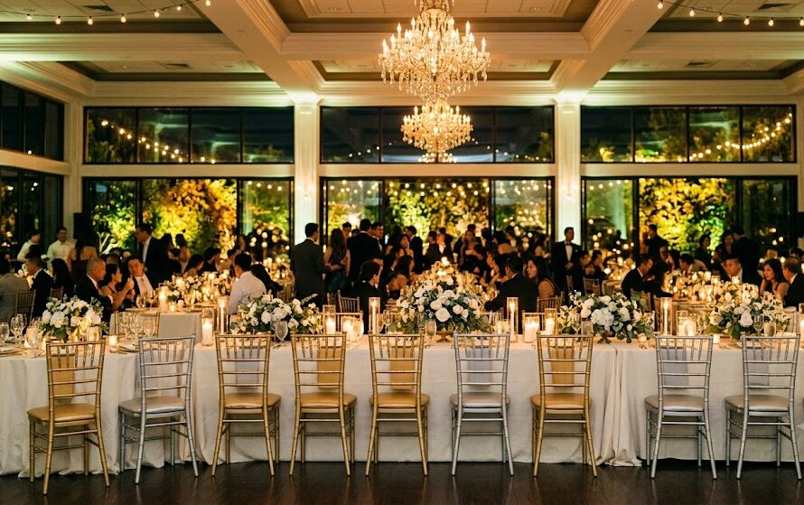 Elegant indoor wedding ballroom reception featuring gold Chiavari chair rentals in San Jose.